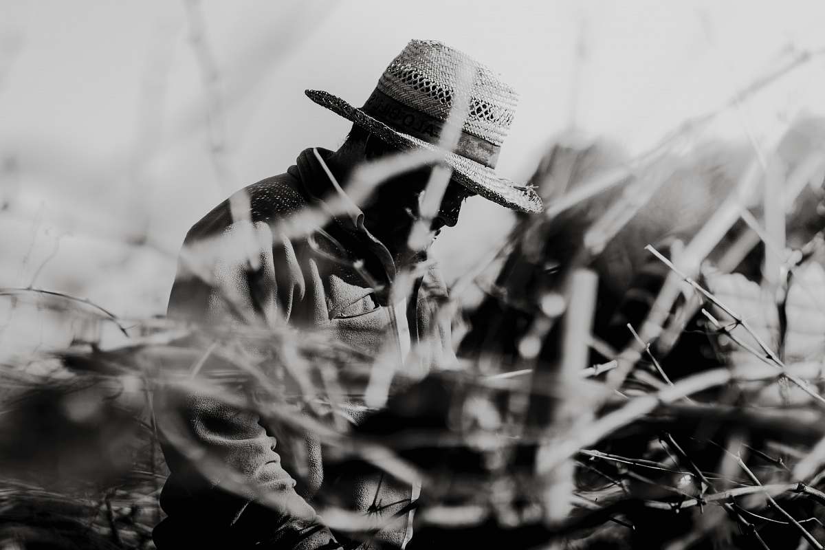 canary islands grayscale photography of man wearing hat spain